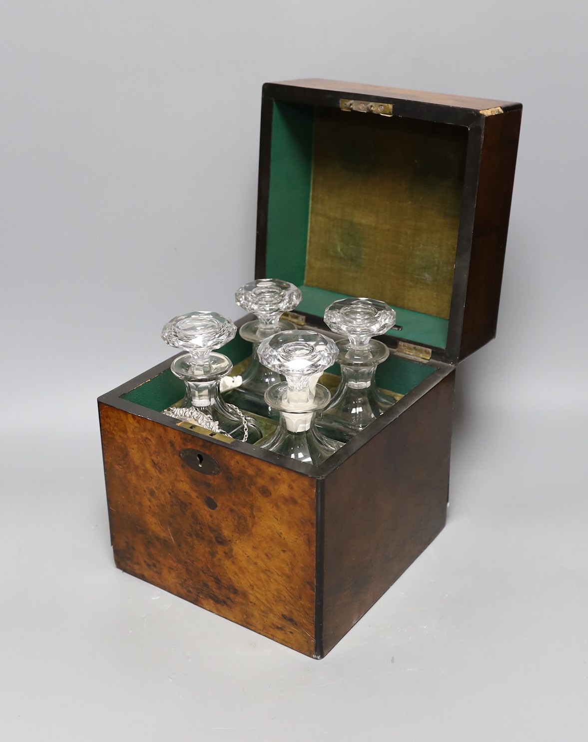 A Victorian burr walnut 4 bottle decanter box, four glass decanters and a silver ‘port’ label, 24cm high
